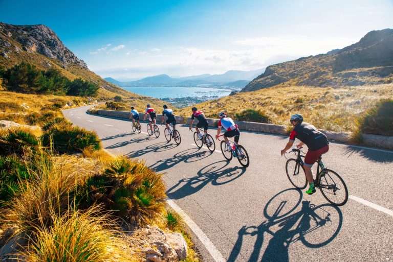 SPORT'N GO training camp featuring a group road bike ride in a natural setting